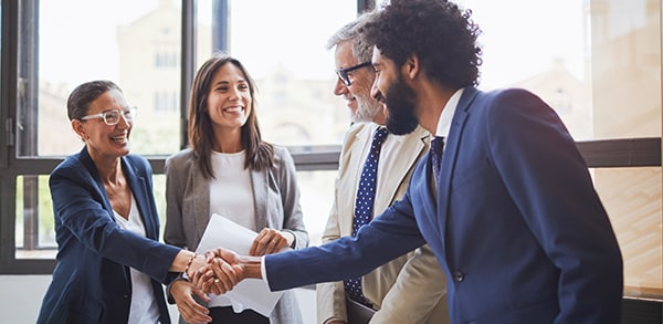 Group of coworkers shaking hands