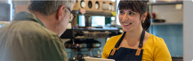 Shopkeeper smiling at an older man