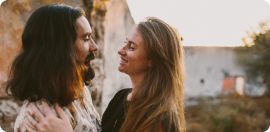 Man and a woman embracing and looking at each other smiling