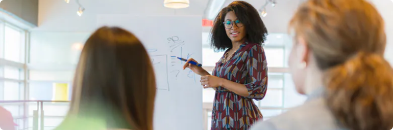 woman standing at whiteboard