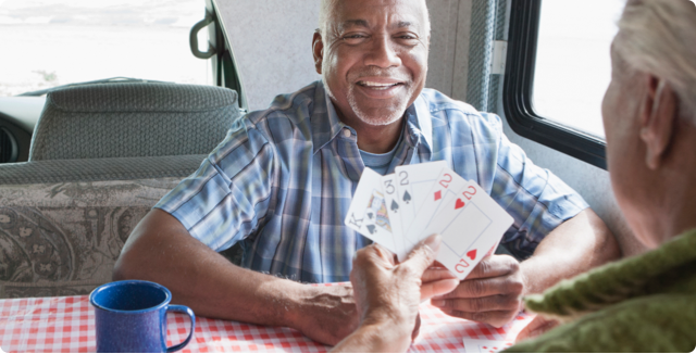 A man smiling while playing cards