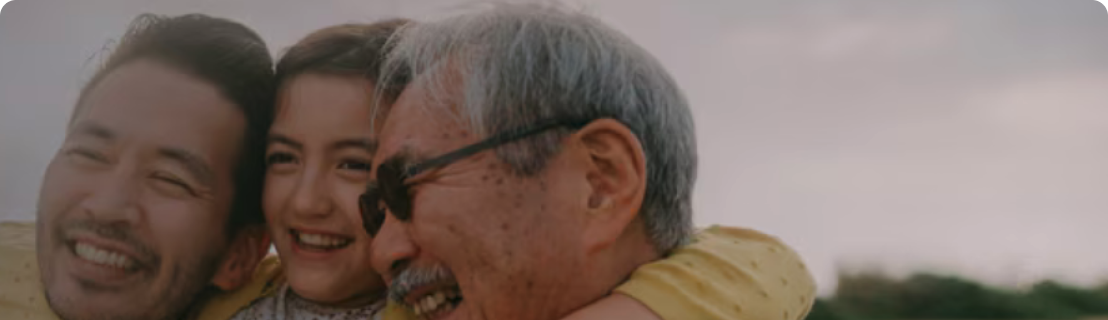 Father and grandfather holding daughter and smiling