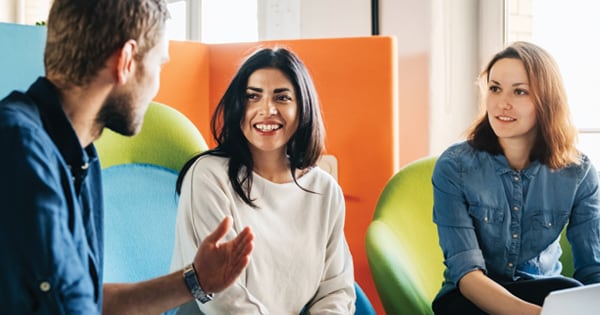 Man sitting and talking with two women