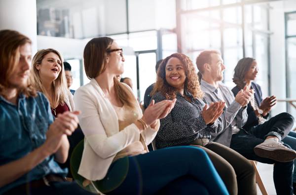 group of more than five people clapping in their seats