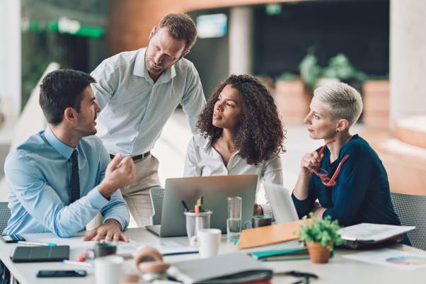 two males and two females collaborating in office setting